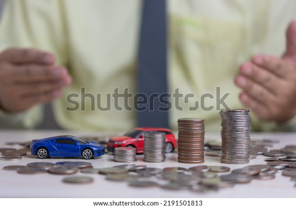 Coin money stack and car toy business investment\
accounting finance inflation growth.Saving money economics plan\
insurance concept.