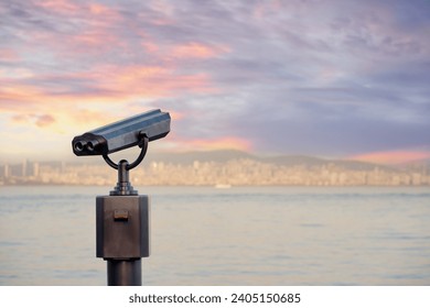 Coin Operated Binocular viewer next to the waterside promenade looking out to the bay and city. - Powered by Shutterstock