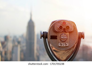 Coin operated binoculars in sunset light Top of the Rock, New York City  - Powered by Shutterstock