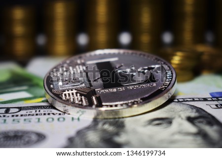 Coin physical Litecoin LTC, background from banknote and golden coins.