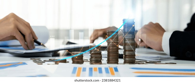 Coin stack with digital graphic indicator symbolizing business investment and economic growth. Businessman doing financial planning to achieve financial goal and contribute to profit. Shrewd - Shutterstock ID 2381884321