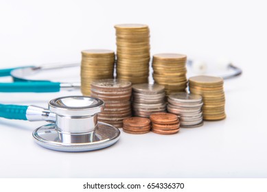 coin stack growing business with medical instruments stethoscope, Saving money concept.