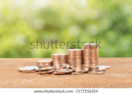 Coin stack on green tree background
