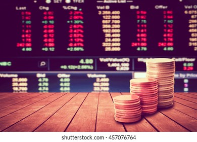 Coin Stack On Perspective Wooden Floor With Blur Stock Market Number Background