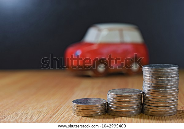 coin stacks\
in front of car. Saving money\
concept.