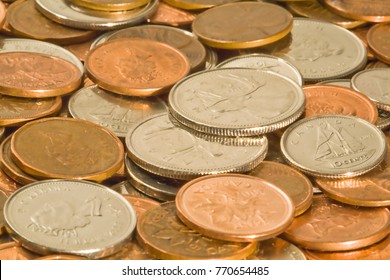 Coins in all nominations viewed in an angle that shows the texture and color of the coins best in a warming light glow.