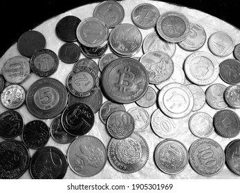 Coins Of Different Countries In Black And White Photo.