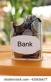 Coins in a glass container with a label bank . Financial concept.