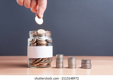 The coins are in a glass jar . Investment concept. Economic growth. Business management. Capital accumulation. Financial literacy. - Shutterstock ID 2113148972