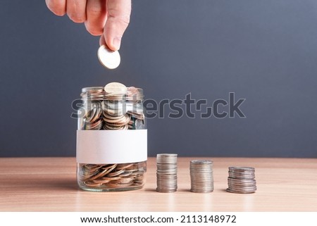 The coins are in a glass jar . Investment concept. Economic growth. Business management. Capital accumulation. Financial literacy.