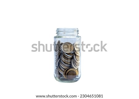 Coins in glass jar isolated on white background. Saving money concept.