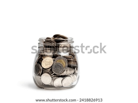 Coins in glass jar isolated on white background. Investment and interest concept, with clipping path