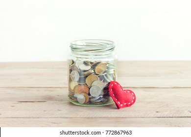 Coins In Glass Jar With Red Heart. Money Savings, Charity And Donation Concept, Copy Space.