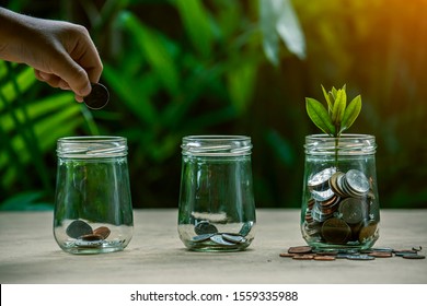 Coins in glass jar set on wooden plates, 