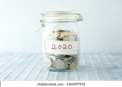 Coins In Glass Money Jar With 2020 Label, Financial Concept.