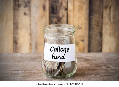 Coins In Glass Money Jar With College Fund Label, Financial Concept. Vintage Wooden Background