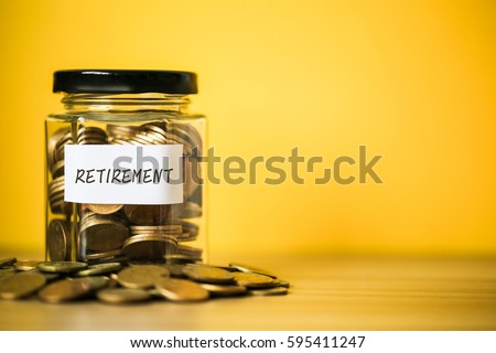 A lot coins in glass money jar with yellow background. Saving for Retirement concept.