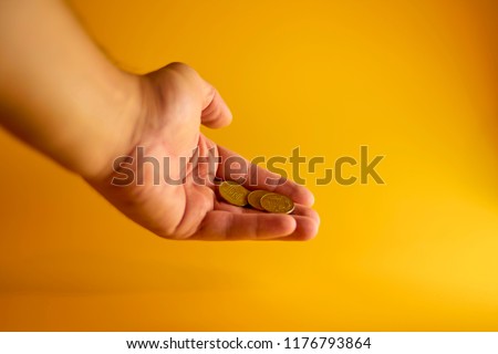 Coins in the hand. The concept of cheaper currency