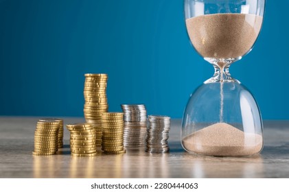 Coins and hourglass on wooden table
 - Powered by Shutterstock