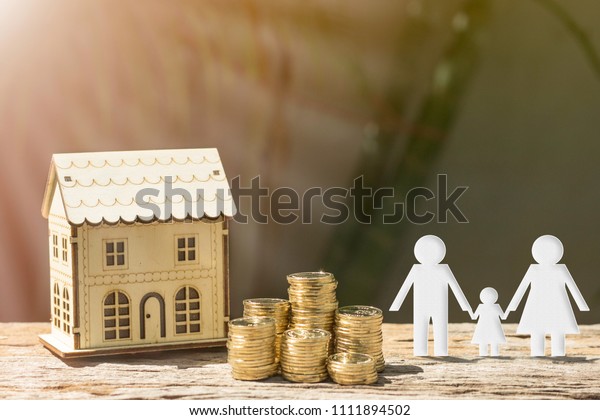 Coins and house and family\
show savings to buy a home or buy real estate. Or show a home loan\
Or divide the investment for retirement. Or for the future Concept\
of money