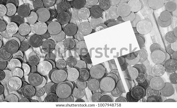 Coins in a jar on the floor.\
Accumulated coins on the floor. Pocket savings in\
piles.