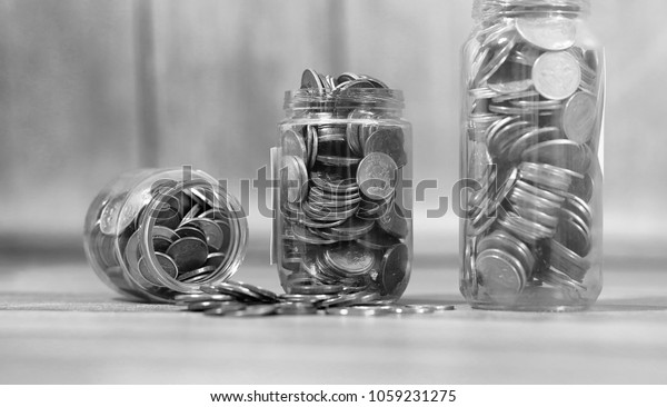 Coins in a jar on the floor.
Accumulated coins on the floor. Pocket savings in
piles.