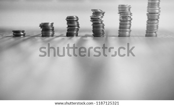 Coins in a jar on the floor.\
Accumulated coins on the floor. Pocket savings in\
piles.\
