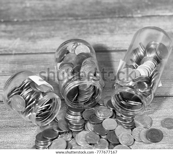 Coins in a jar on the floor.
Accumulated coins on the floor. Pocket savings in
piles.
