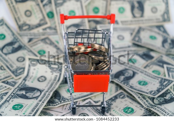 Coins in the mini\
market trolley. on\
dollars