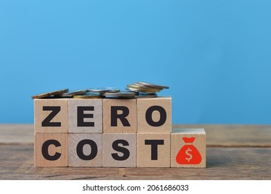 Coins, money symbol and wooden blocks with text ZERO COST