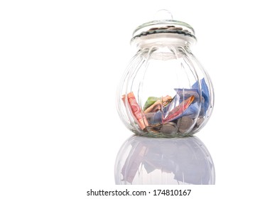 Coins And Paper Money In A Cookie Jar