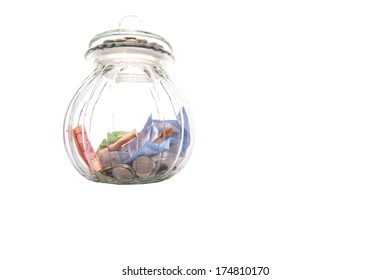 Coins And Paper Money In A Cookie Jar