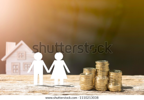 Coins and\
people and house blur background show savings to buy a home or buy\
real estate. Or show a home loan Or divide the investment for\
retirement. Or for the future Concept of\
money