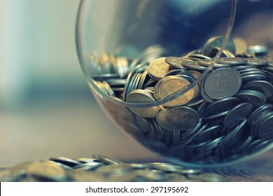 coins in a piggy bank vase