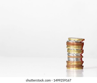 Coins Piled Up On A Shiny Surface No People Stock Photo