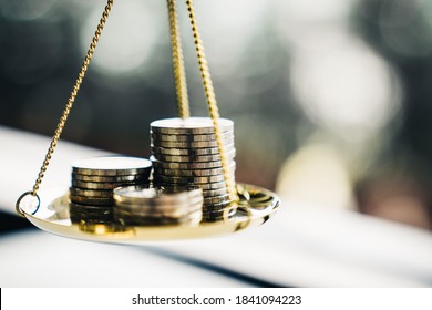 Coins stack with balance scale. Money management, financial plan, time value of money, business idea and Creative ideas for saving money concept.  - Shutterstock ID 1841094223