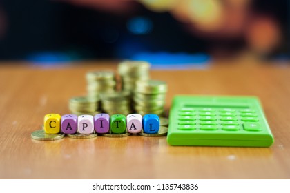 coins stack and dice alphabet with text capital