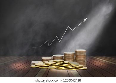 Coins Stack With Lighting And Smoke On Wooden Stage And Chart Of Indicators 