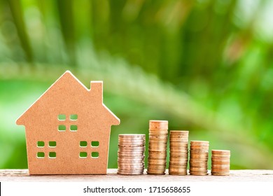 Coins stack of money and model house on natural green background,Business finance investment and real estate concept