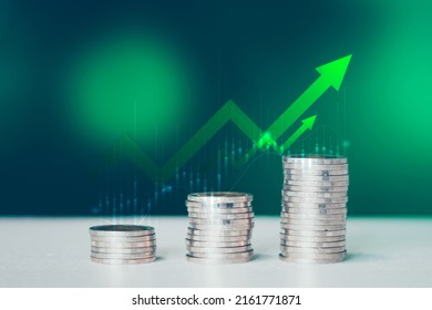Coins stack of money on saving, the step of the financial stock market, graph and rows of coins, business investment on a green background, Economy stock market growth of financial recovery.