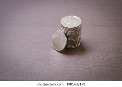 Coins stack on dark background. Baht currency