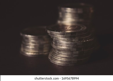Coins stacked on each other in different positions on dark background. Money concept. Closeup. Money and saving concept. Success, wealth and poverty, poorness concept. Business Growth concept - Shutterstock ID 1695678994