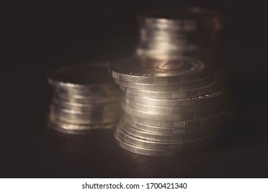 Coins stacked on each other in different positions on dark background. Money concept. Closeup. Money and saving concept. Success, wealth and poverty, poorness concept. Business Growth concept - Shutterstock ID 1700421340