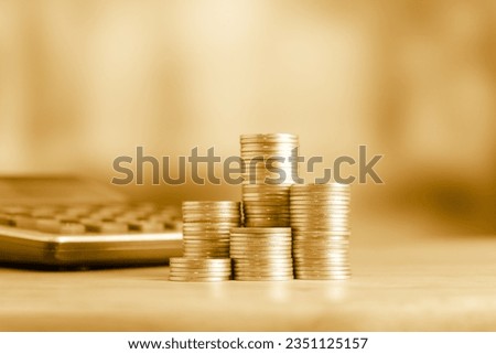 Coins stacks and coin on golden background, business and finance concept idea.