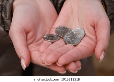 Coins In Womens Palms. Financial Hardship Concept. Background