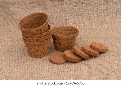 Coir Plant Pots And Compressed Compost On Hessian. Environmentally Friendly Spring Gardening.