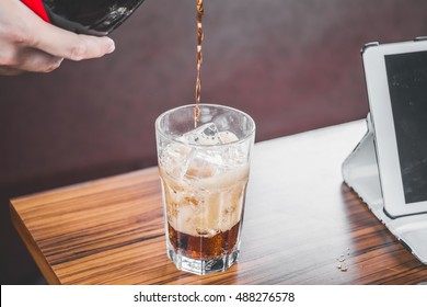 Coke Splashing From Glass On Wood Table Good Photo