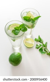 Coktail Gin Tonic Or Mojito In Glass With Mint, Ice, Lime On The White Background.