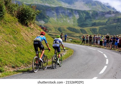 Col de la Madeleine, France - August 24, 2020: Rear view of two cyclists (Michael Schar and Xandro Meurisse) climbing the road to Col de la Madeleine during the 3rd stage of Criterium du Dauphine 2020