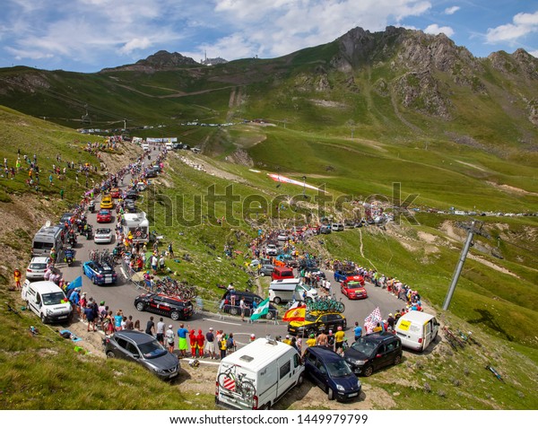 Col\
du Turmalet, France - July 27, 2018: Technical vehicles are\
climbing,after the peloton, the road to Col du Tourmalet in\
Pyrenees during the 19 stage of Tour de France\
2018.